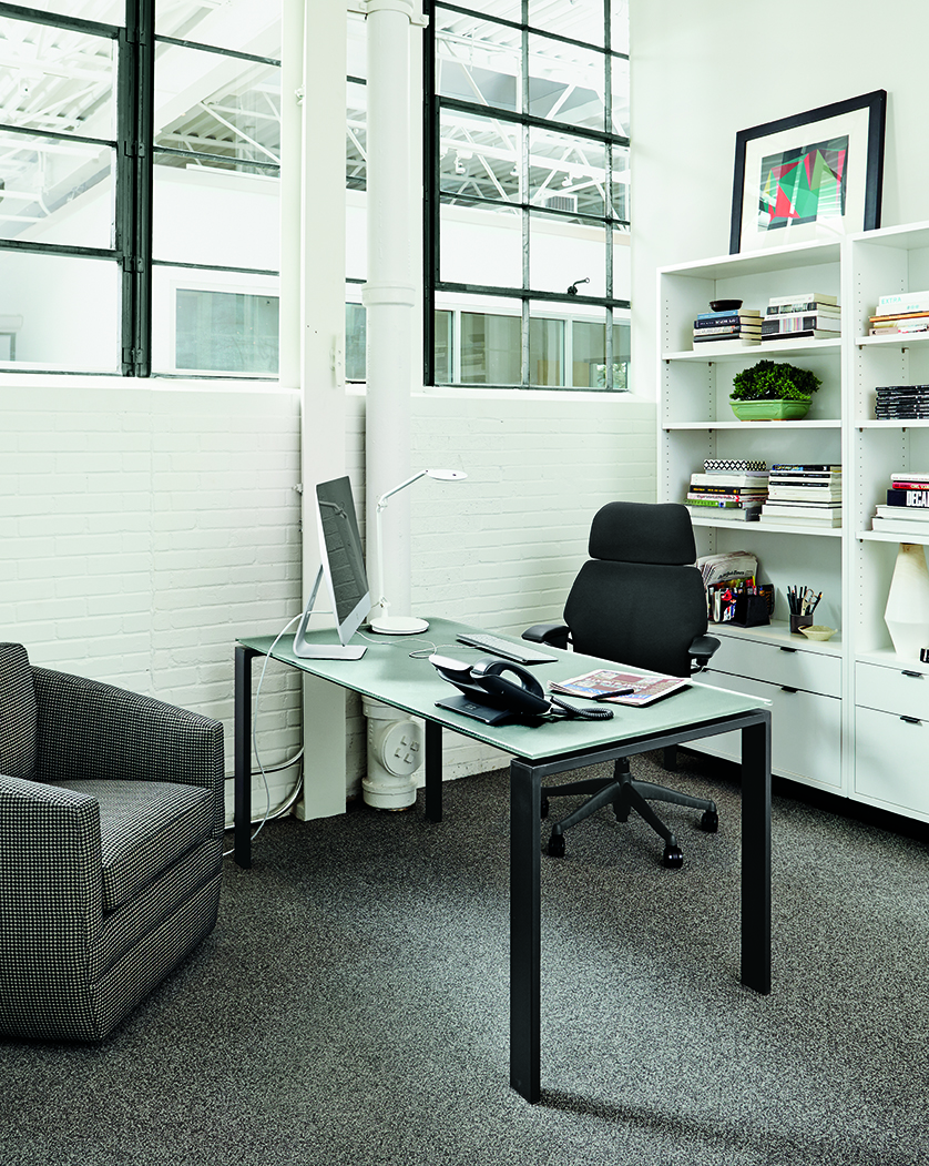 Office with Rand table in natural steel and grey glass and Copenhagen bookcases in white.